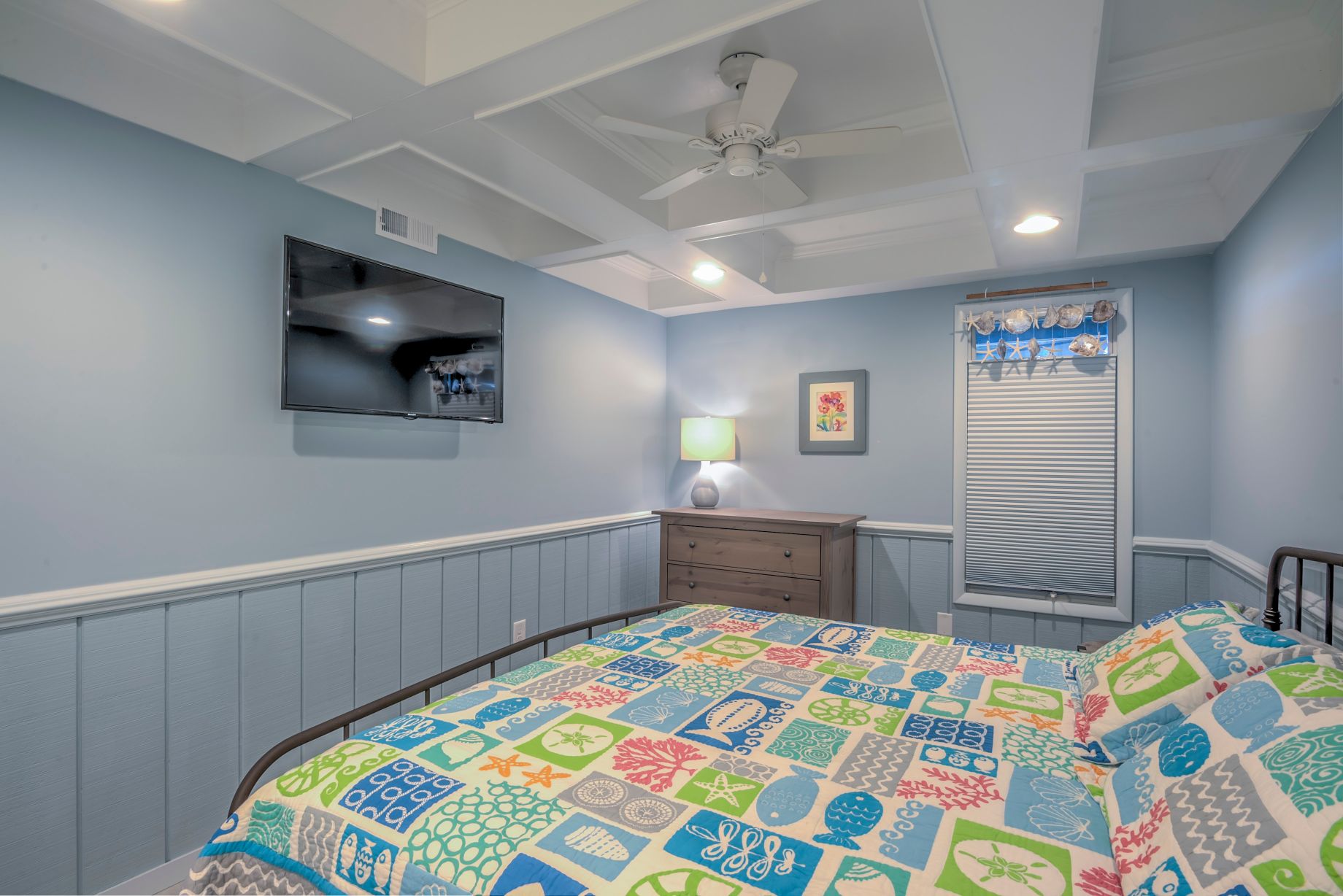 Renovation in Campbell Place, Bethany Beach DE - Bedroom with White Ceiling Fan and Sea Themed Details Above Window Blinds