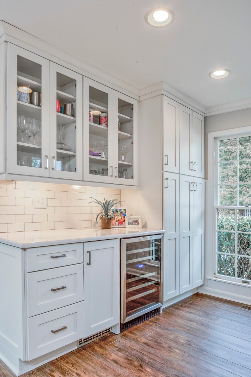 Canal Way Kitchen Remodel in Bethany Beach DE with Wine Cooler, White Cabinets and White Subway Tile Backsplash