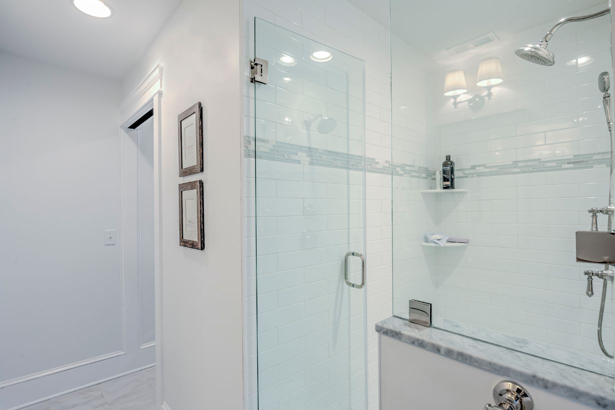 Bathroom with White Walls and Frameless Glass Shower Door