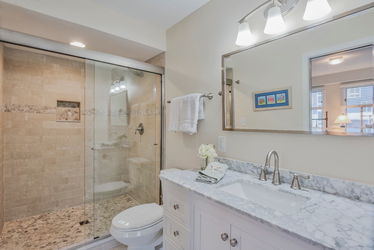 Indian Street New Addition in Bethany Beach DE - Bathroom with Large Mirror and Sliding Glass Shower Door