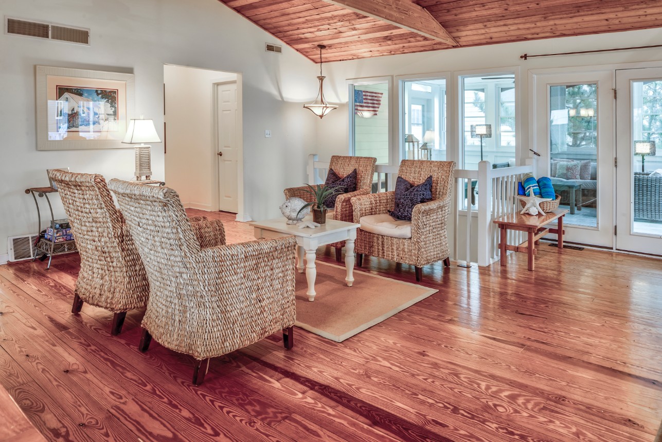 Indian Street New Addition in Bethany Beach DE - Family Room with Four Rattan Chairs and Medium Wood Floor and Ceiling