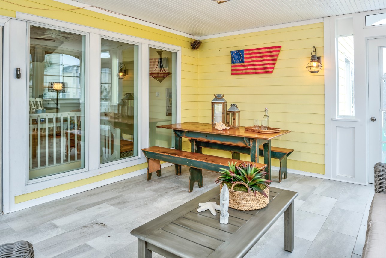 Indian Street New Addition in Bethany Beach DE - Sunroom with Yellow Siding and Wall Mount American Flag