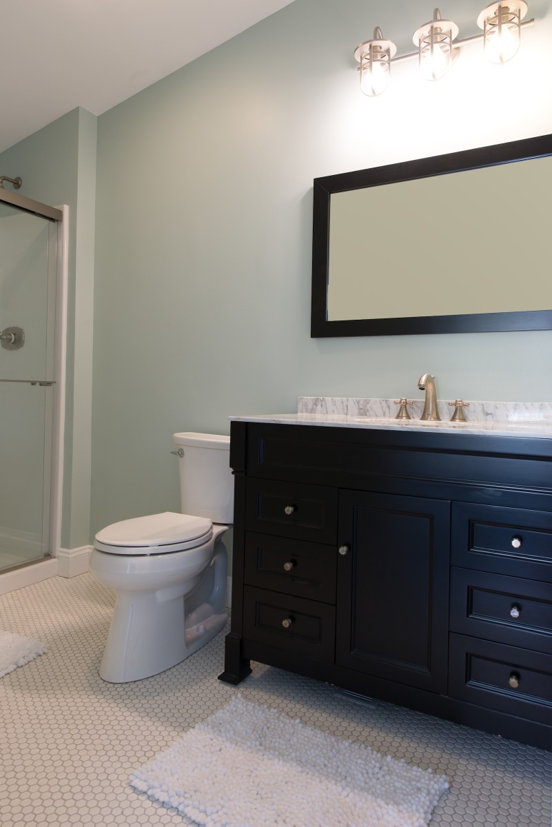 Kent Renovation Bethany Beach, DE Bathroom with Honeycomb White Floor Tiles, Dark Wood Vanity and Sea Foam Wall Paint
