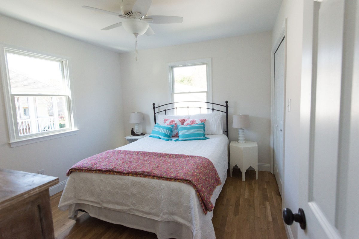 Kent Renovation Bethany Beach, DE Bedroom with White Paint Walls, Wood Flooring, Large Double Bed and White Ceiling Fan