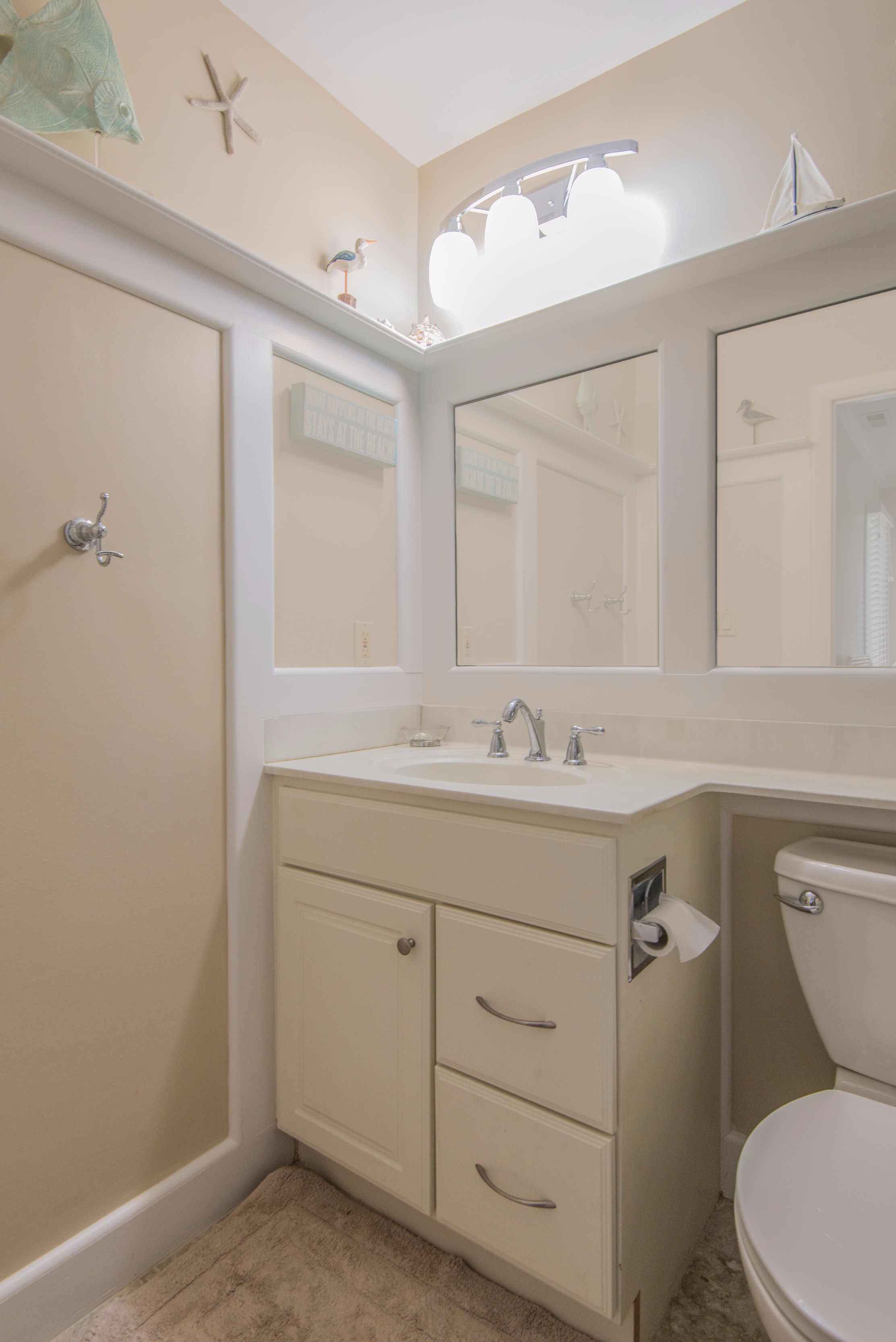Bathroom Remodel in Kings Grant, Fenwick Island DE with Mantel Above Full Length Mirror and White Vanity With White Top