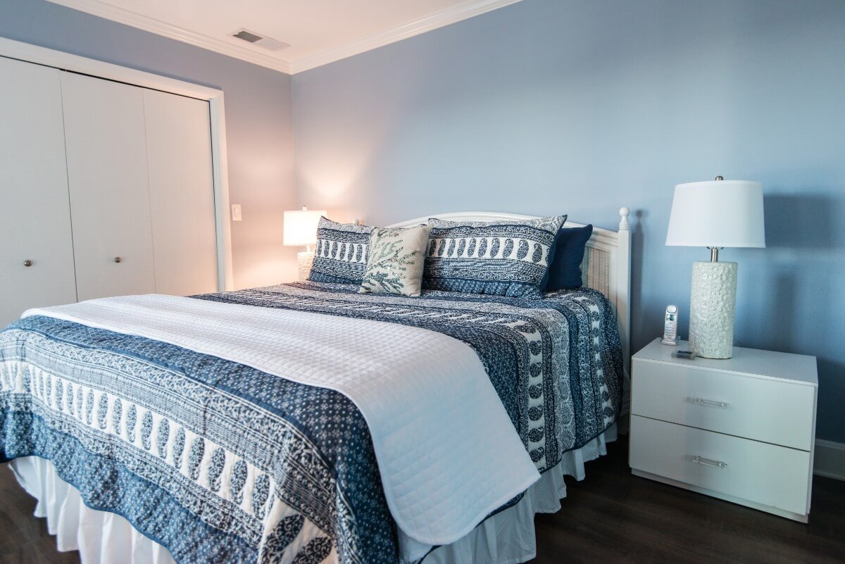 Kings Grant Renovation Vol.3 Blue Painted Bedroom with White Flat Night Stand, Dark Wood Floor and White Closet