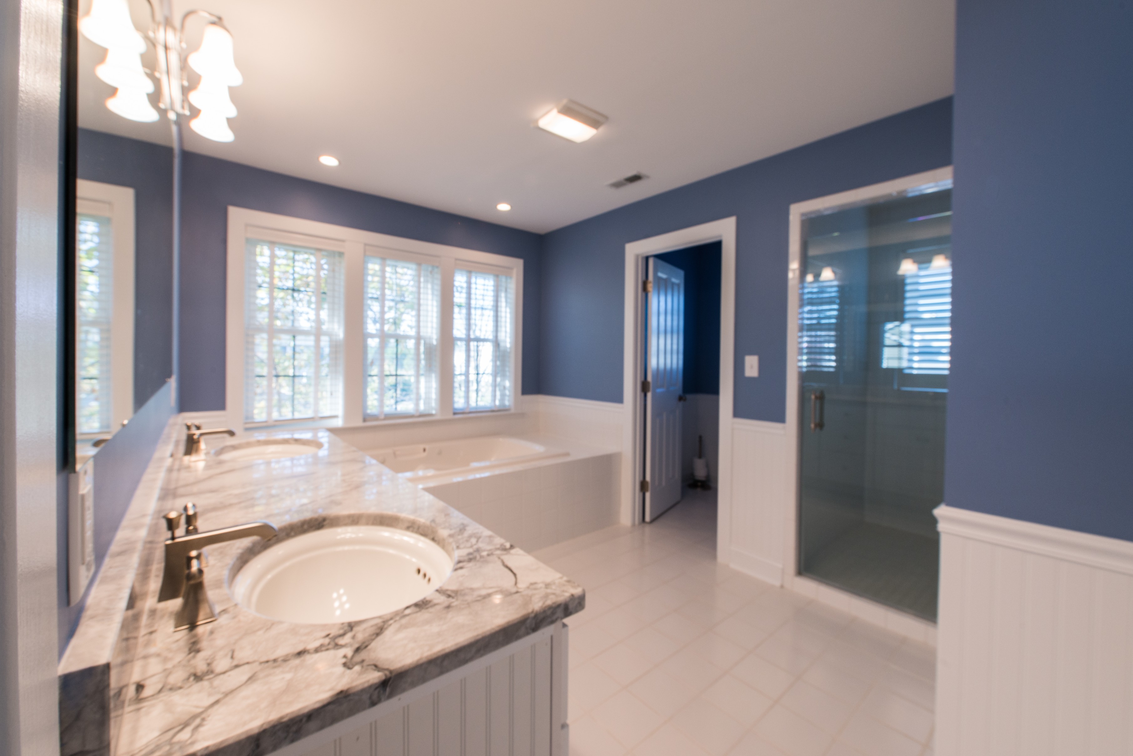 Bathroom Remodel in Ocean Ridge, Bethany Beach DE with Purple Walls, Undermount Two Sinks and White Tile Floor