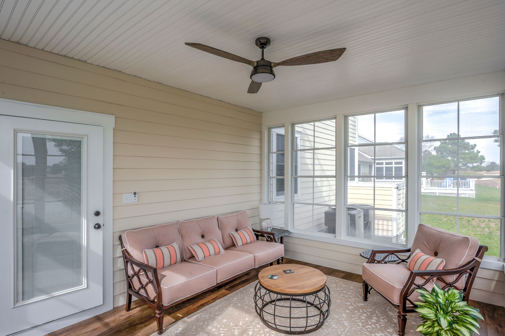 October Glory Exterior in Ocean View DE - Sunroom with Vintage Ceiling Fan and Round Coffee Table