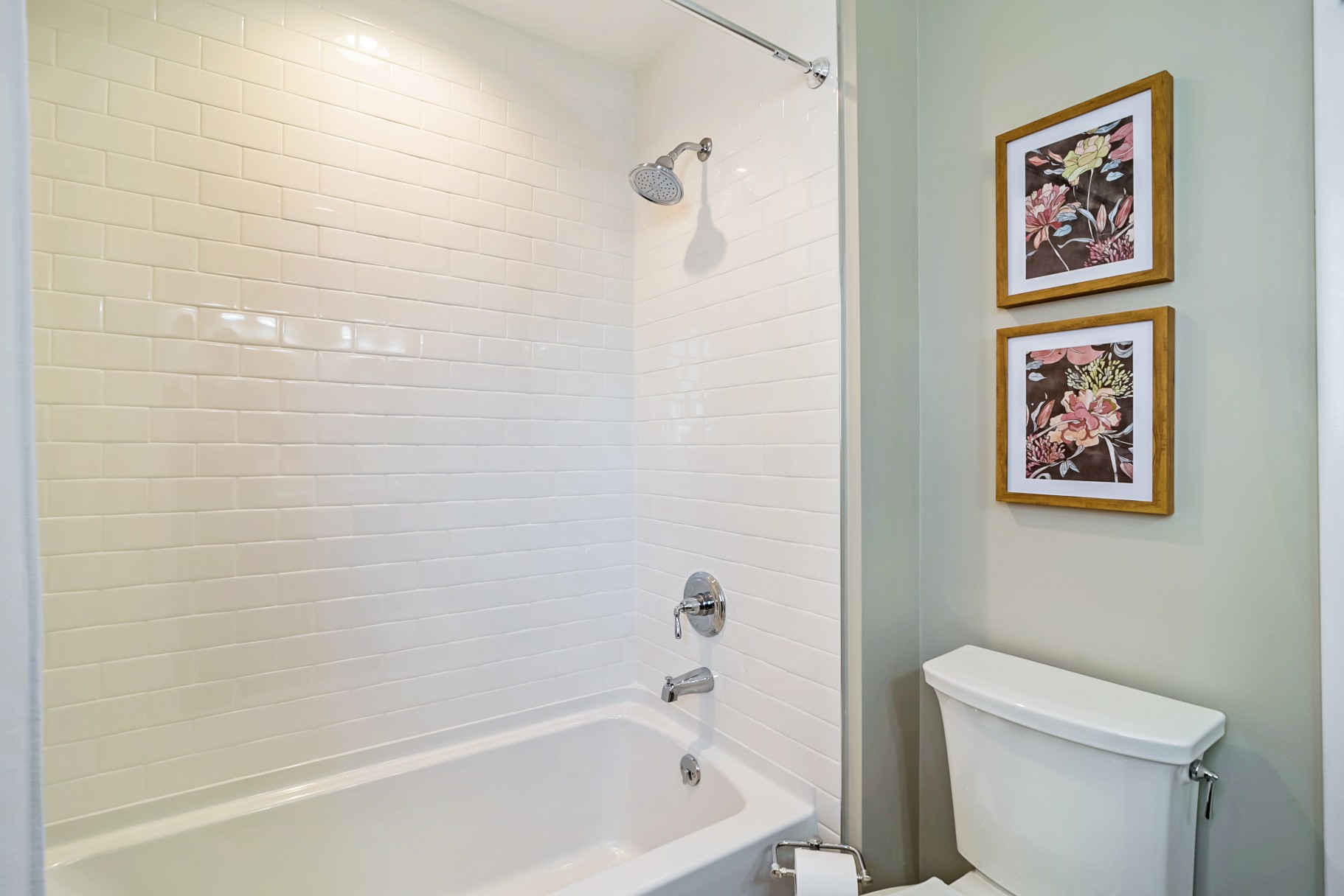 Bathroom with White Subway Tiles and Flower Paintings in Wellington Parkway, Bethany Beach DE Renovation