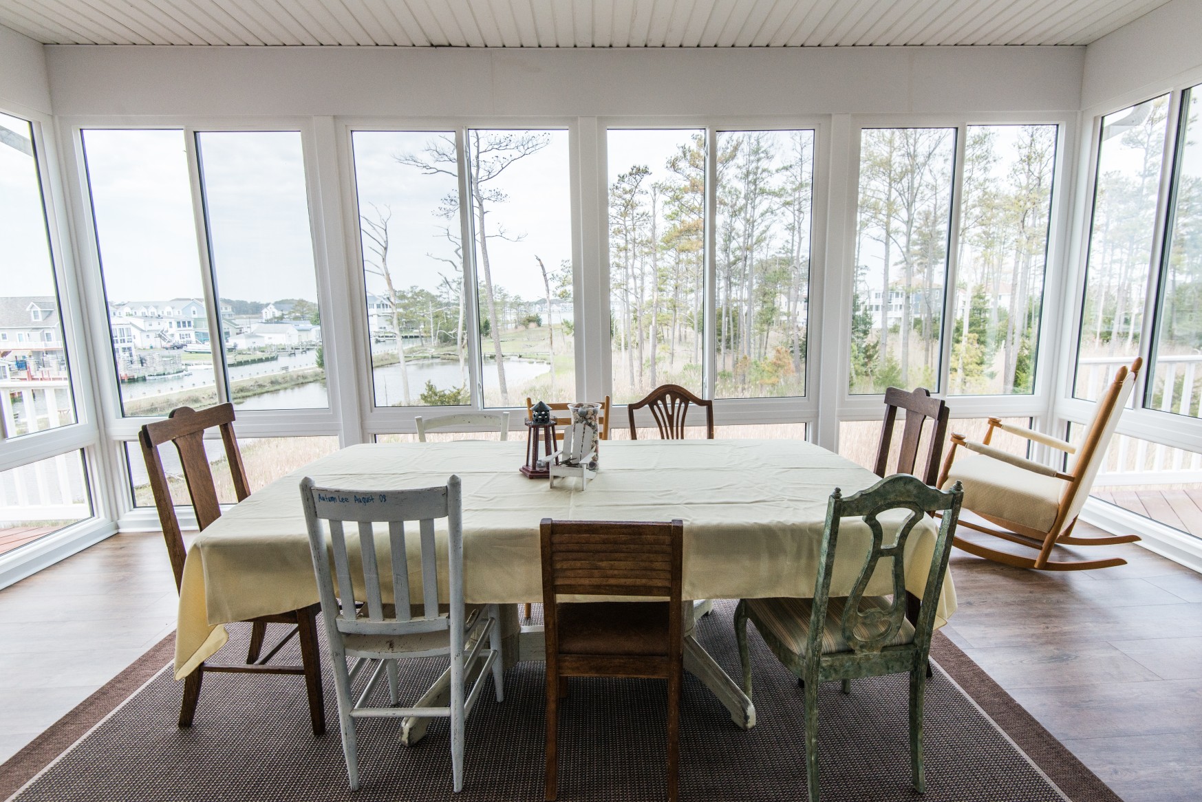 Whitesview Court Sunroom Vol.2 in Ocean View DE Between Two Decks with COREtec Plus Flooring and Large Table