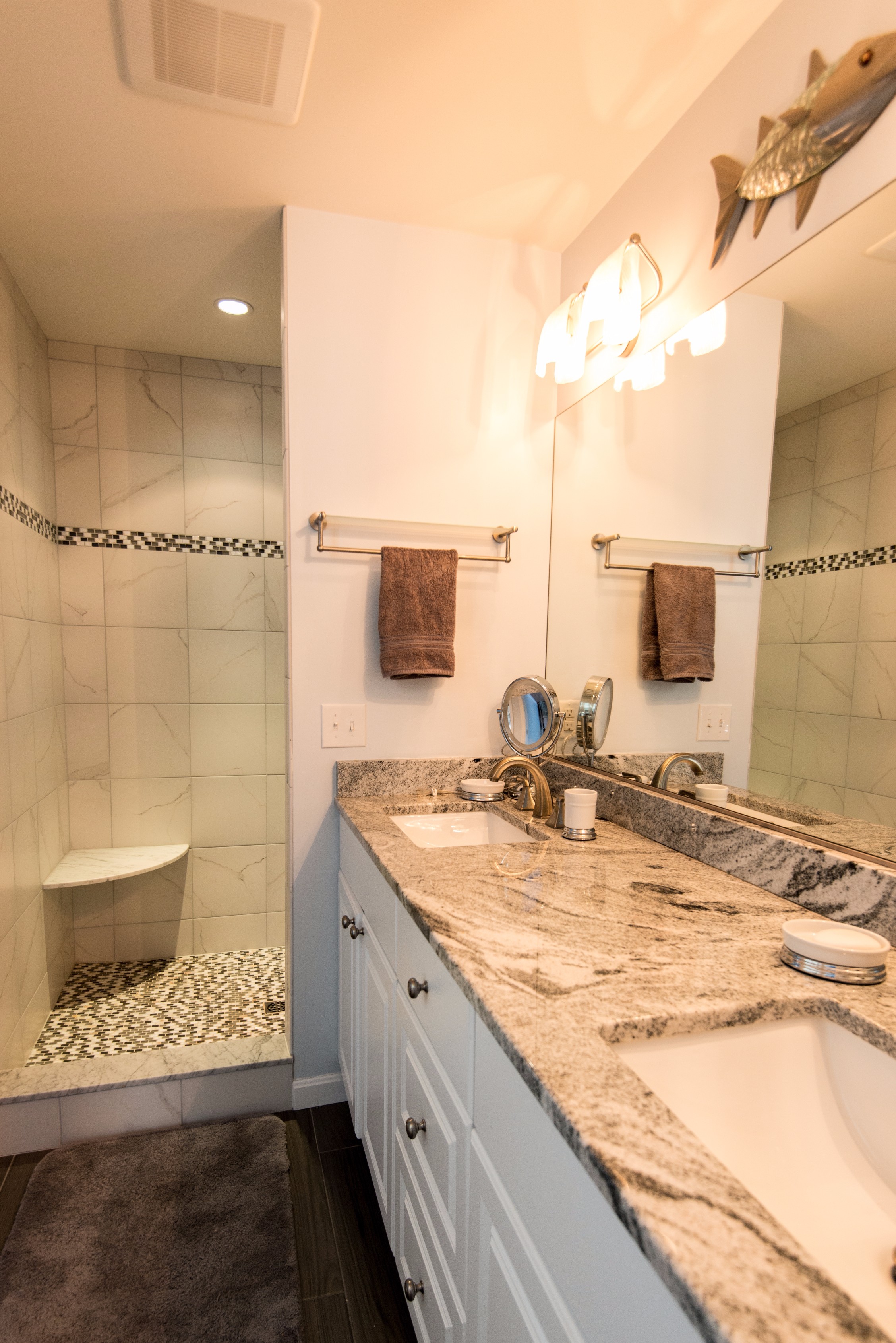 Bathroom Remodel in Willow Oak, Ocean View DE with Dark Wood Floor, Double Bowl, White Vanity Cabinet and Full Length Mirror